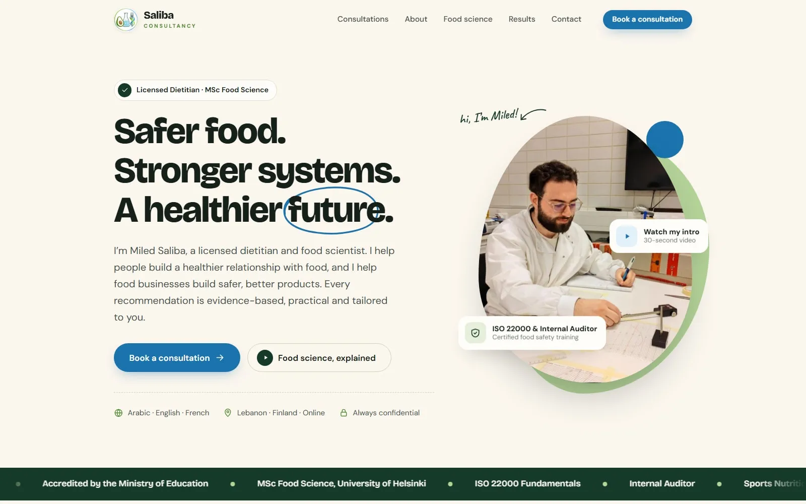 The Saliba Consultancy homepage. The headline “Safer food. Stronger systems. A healthier future.” sits beside a circular photo of Miled Saliba working at a desk, with Book a consultation and Food science, explained buttons.
